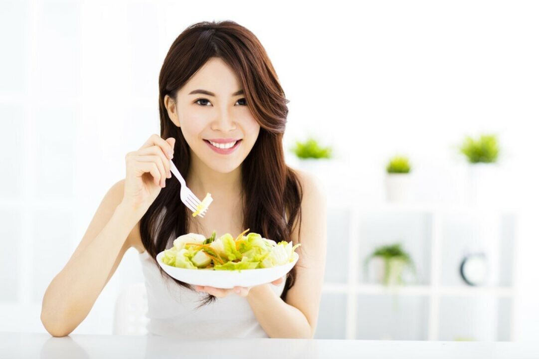 A Japanese woman eats salad